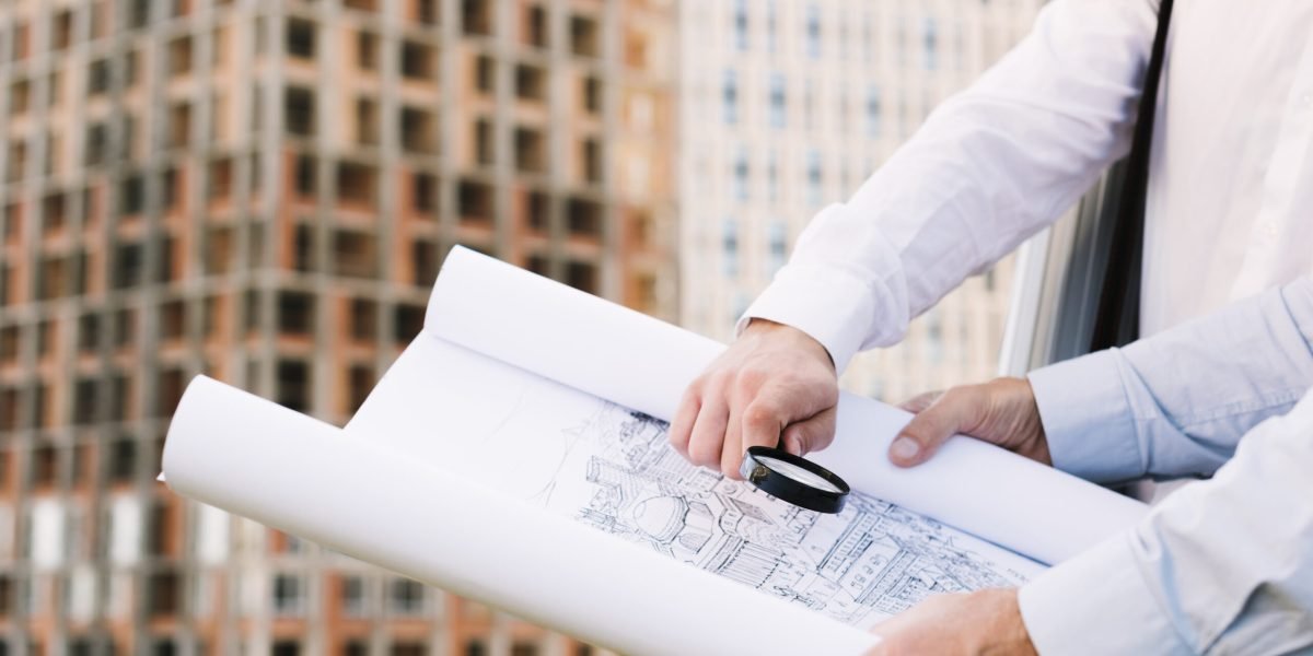 close-up-people-holding-building-sketch