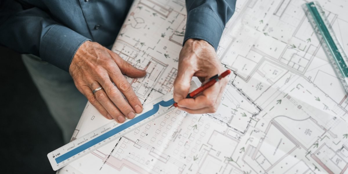 high-angle-view-man-working-blueprint